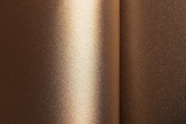 Fondo de papel caluroso marrón y dorado con una textura metálica perlada y efecto reluciente