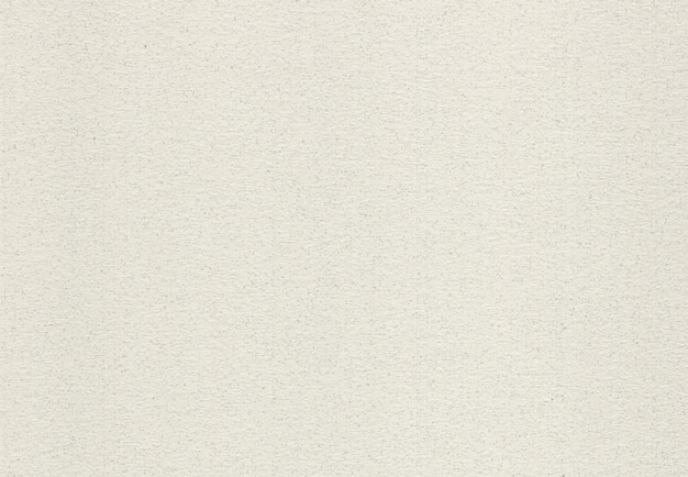 Fondo de papel de color beige pálido reciclado con inclusiones de pequeñas fibras naturales