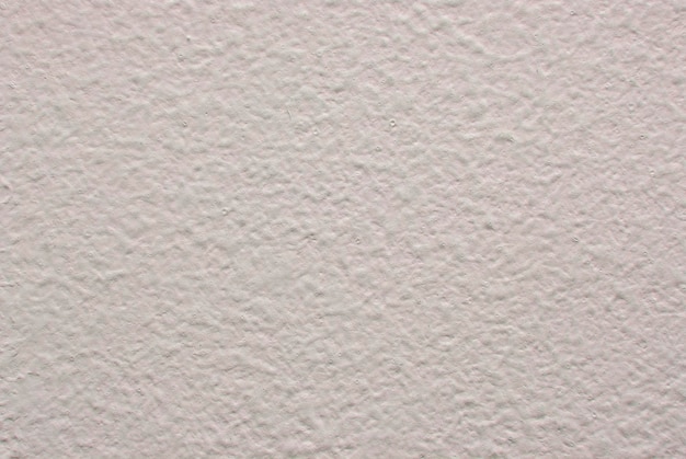 Fondo de pared blanco y áspero en tono rosa