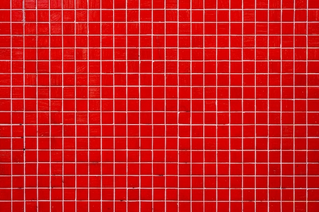 Foto el fondo de una pared hecha de azulejos de mosaico rojo