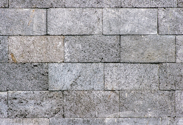 Fondo de pared de piedra a cuadros oscuro natural