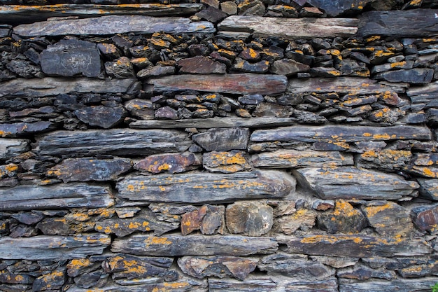 Fondo de pared de piedra y telón de fondo, piedras antiguas en la aldea