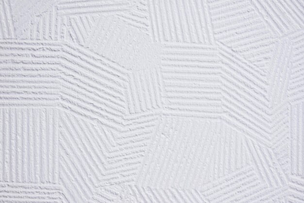 Fondo de pared de yeso blanco con patrón decorativo abstracto