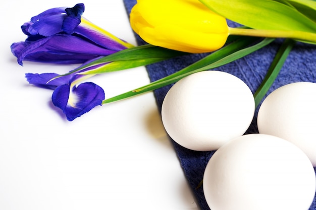 Fondo de pascua con huevos blancos y flores de primavera