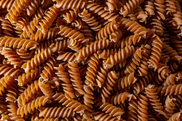 Foto fondo de pasta fusilli de grano entero sin cocer