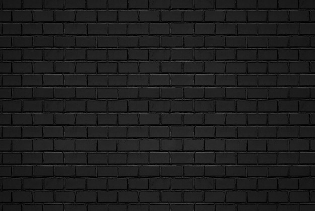 Foto fondo de patrón de pared de ladrillo negro abstracto y telón de fondo negro, espacio de copia en blanco.