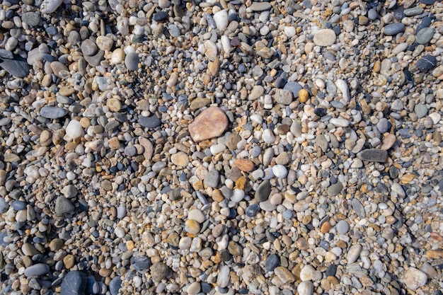 Fondo de pequeños guijarros y piedras en la orilla del mar o en el jardín