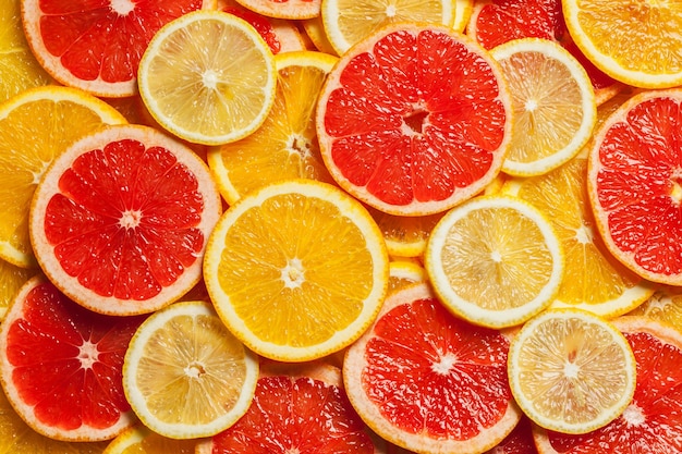 Fondo de rodajas de pomelo naranja limón cítricos coloridos