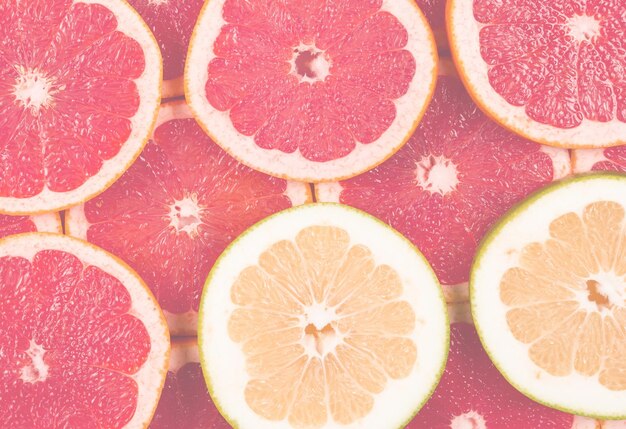 Foto fondo de rodajas de pomelo y pomelo