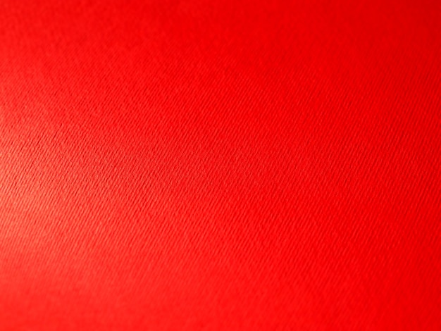 Fondo rojo abstracto con textura Primer plano de la superficie del papel con luz y degradado de color Iluminación lateral Telón de fondo carmesí brillante