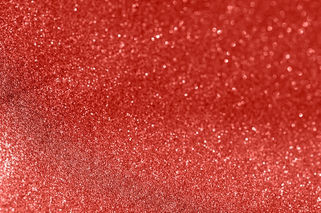 Fondo rojo del extracto de la Navidad de la textura del brillo. Textura brillante del papel de embalaje, elemento del diseño de la tarjeta de felicitación.