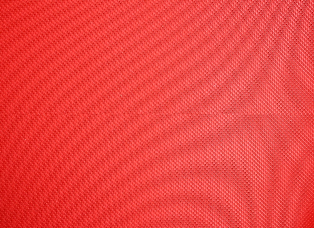 Fondo rojo muy fino de la textura de la tela sintética