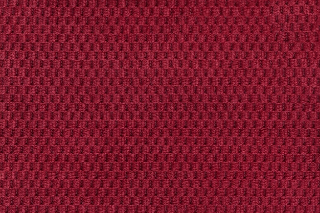 Fondo rojo del primer suave de la tela lanosa. Textura de macro textil