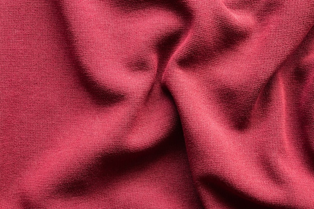 Fondo rojo de la trama de la textura de la tela de la ropa