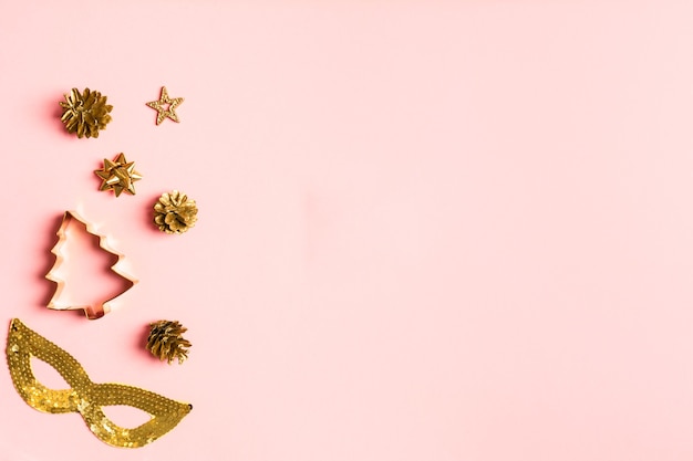 Fondo rosa navideño creativo con colección dorada de juguetes para decoración