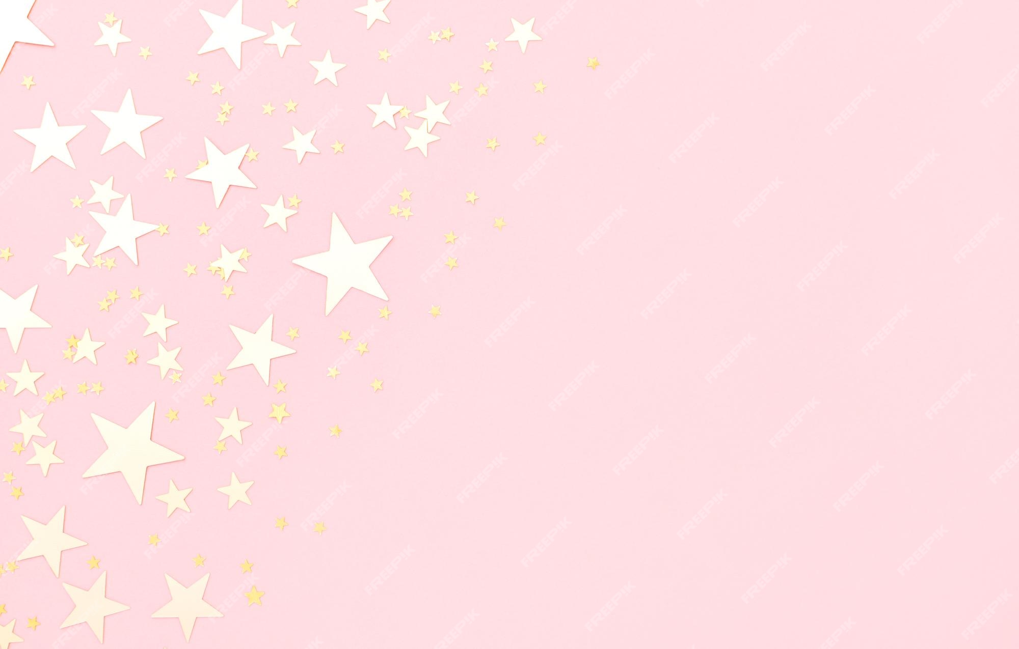 Fondo rosa pastel con estrellas brillantes. | Foto Premium