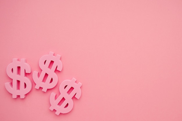 Fondo rosa con símbolos de dólar, signo de dinero