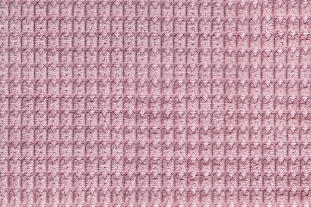 Fondo rosado del cierre suave de la tela lanosa para arriba. Textura de macro textil