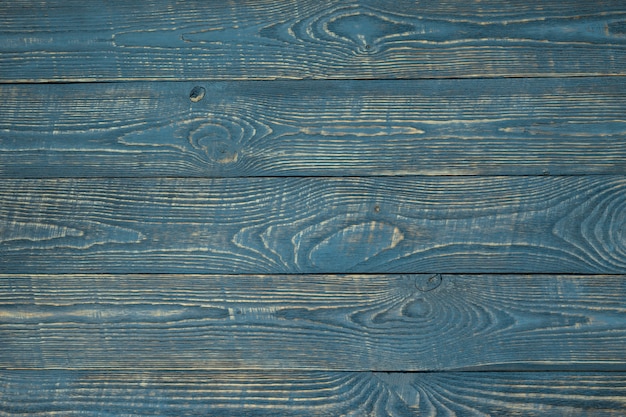 Fondo de tableros de textura de madera con restos de pintura azul. Horizontal.