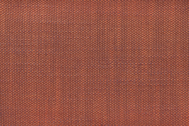 Fondo de textil naranja oscuro, primer plano. Estructura de la macro de la tela.