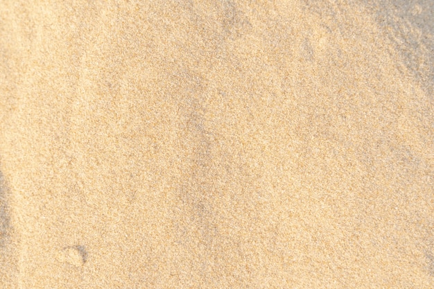 Foto fondo de textura de arena. patrón de desierto marrón en playa tropical. de cerca.