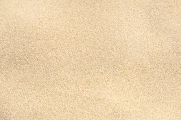 Foto fondo de textura de arena en la playa. patrón de textura de arena de mar beige claro, fondo de playa de arena.