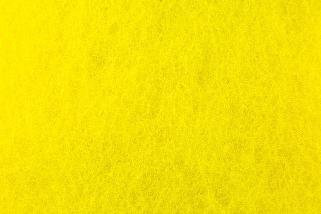 Fondo de textura de esponja amarilla. De cerca, foto macro.