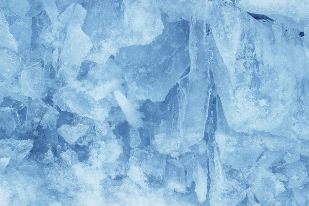 Fondo de textura de grietas congeladas en la superficie del hielo azul