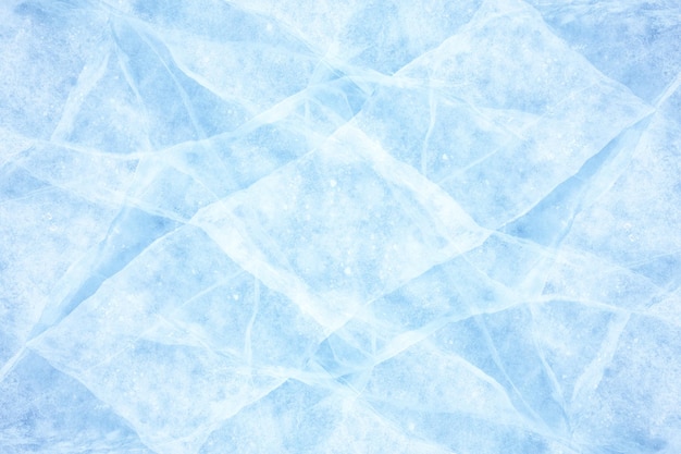 Fondo de textura de grietas congeladas en la superficie del hielo azul