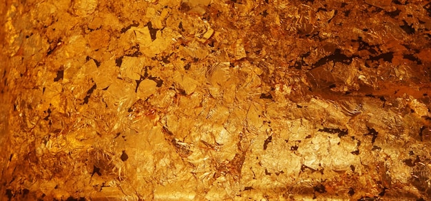 El fondo de textura de hoja de oro oscuro