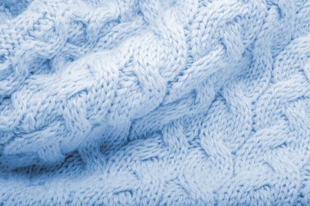 Fondo de textura de lana de tejido de punto azul clásico. Material textil suéter azul cálido