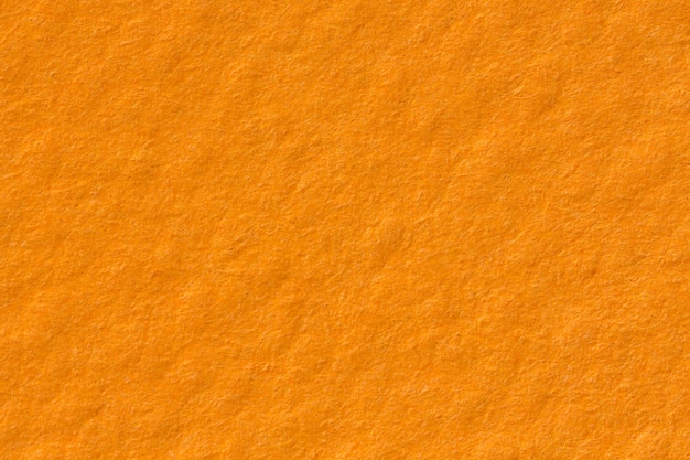 Fondo de textura de papel naranja sobre fondo liso macro