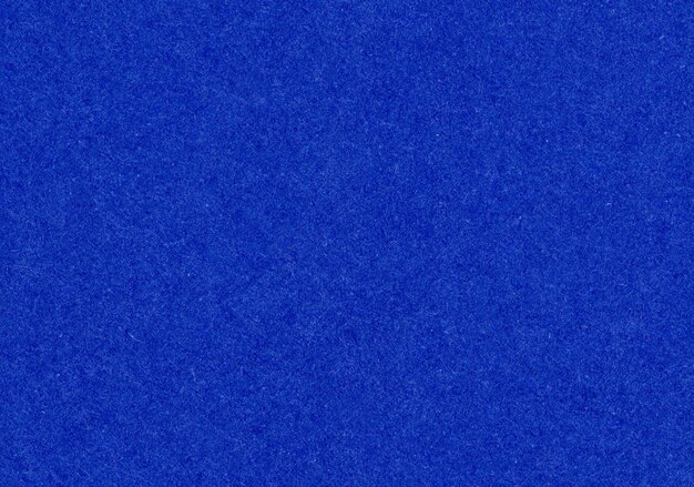 Fondo de textura de papel de primer plano azul oscuro de alto detalle grano de fibra rugosa sin recubrimiento con espacio de copia