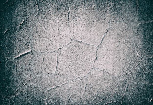 Fondo de textura de pared agrietada y llena de baches