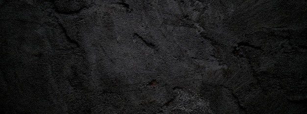 Fondo de textura de piedra granulada áspera de miedo o gris oscuro de pared negra Hormigón negro para fondo