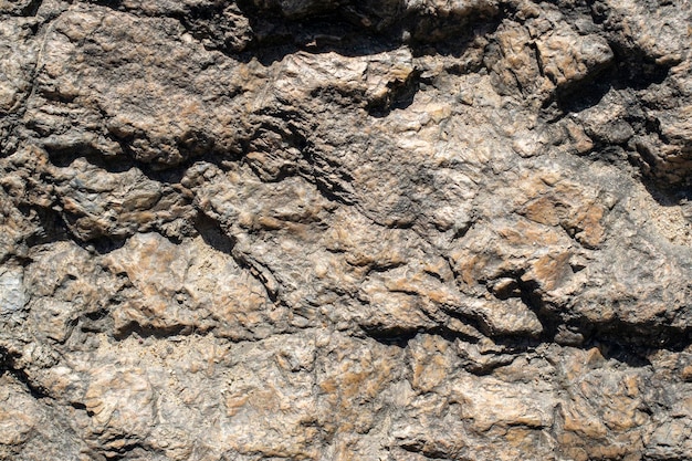 Fondo de textura de roca de granito crudo Fragmento de muro de piedra natural