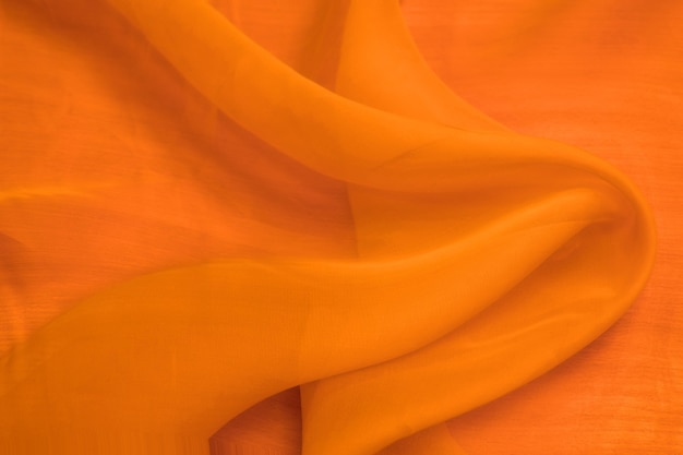 Fondo de textura de satén de seda naranja colorido, textura de tela de tela de algodón rojo