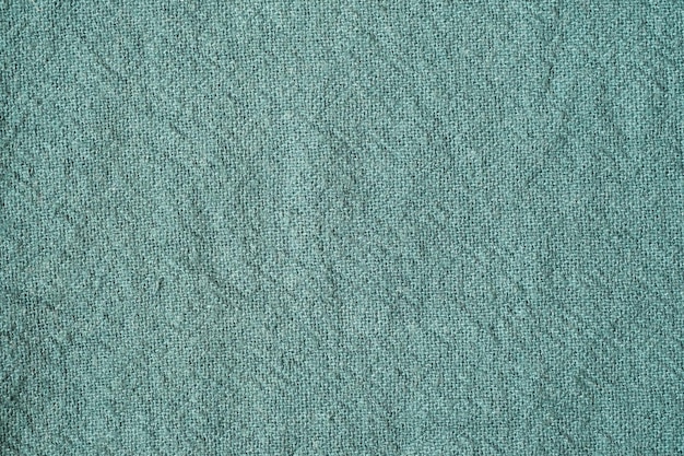 Foto fondo de textura de tela de algodón verde tabla de tapiz textil de superficie arrugada