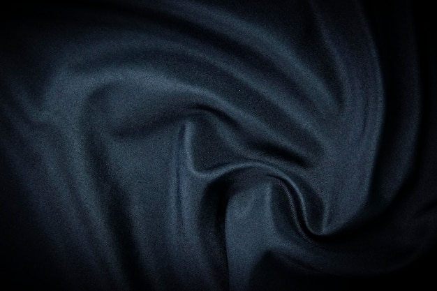 Un fondo de textura de tela azul marino oscuro y una imagen de fondo de tela arrugada