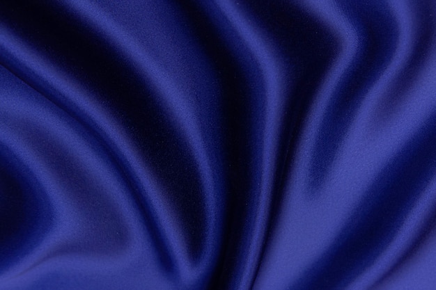 Fondo de textura de tela azul, tela ondulada de color azul suave, textura de tela de seda o satén de lujo.