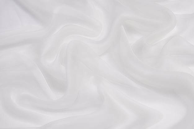 Fondo de textura de tela de gasa suave abstracto. Gasa blanca suave con patrón de curvas y ondas.