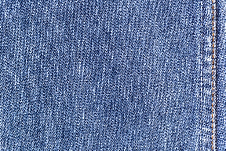 Fondo de textura de tela de mezclilla jeans con costura para la ropa