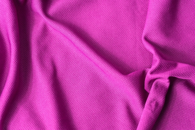 Fondo con textura de tela rosa. Tejido deportivo de tela rosa con textura.