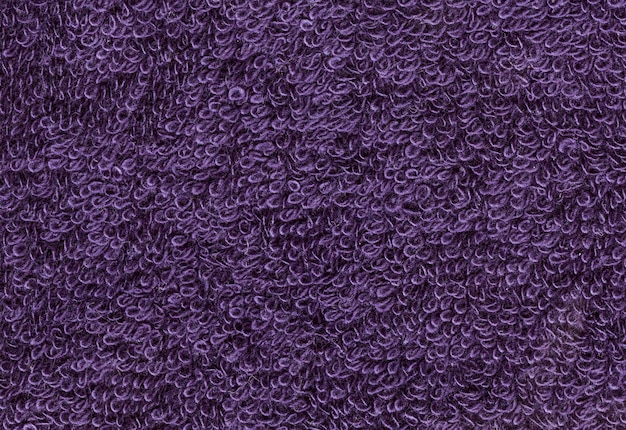 El fondo de la textura de la tela de terrycloth violeta de primer plano de alta resolución