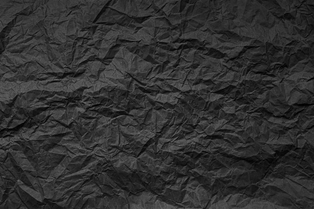 Fondo texturizado abstracto natural de papel negro arrugado