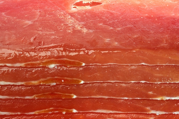 Foto fondo de tienda de carne cortando jamón