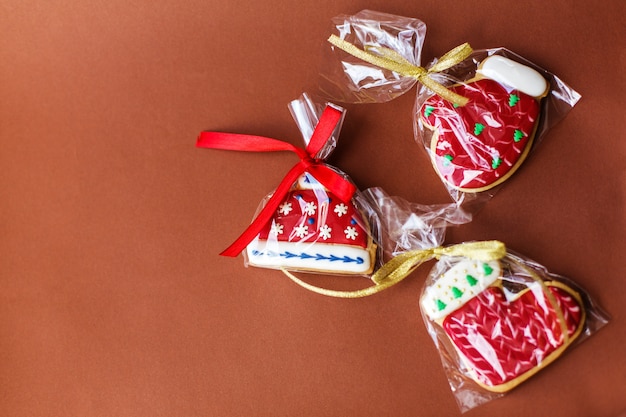 Fondo de vacaciones de año nuevo de Navidad, galletas de jengibre rojo y conos en la mesa de color rojo oscuro. Copia espacio