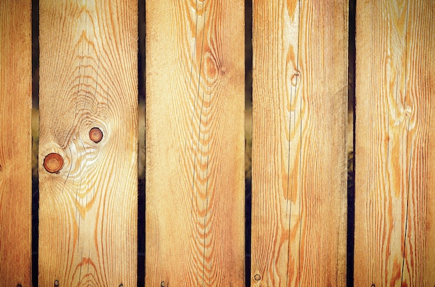 Foto fondo de una valla de madera marrón amarillenta