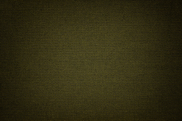 Fondo verde oscuro de un material textil. Tejido con textura natural. Fondo.