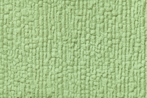 Fondo verde de tela suave y vellosa. Textura de primer plano textil